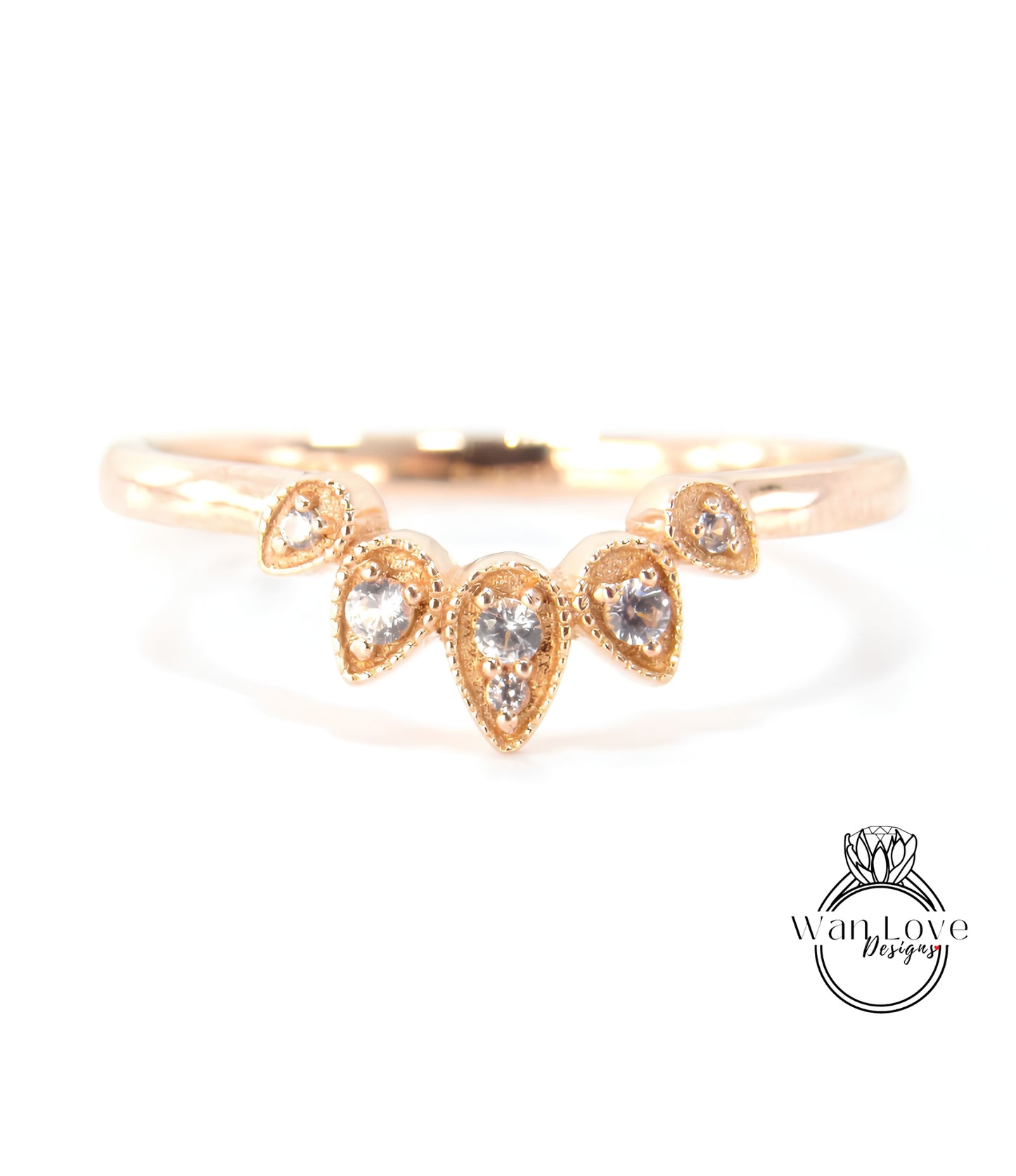 A gold ring with a decorative band featuring a cluster of small, clear gemstones.