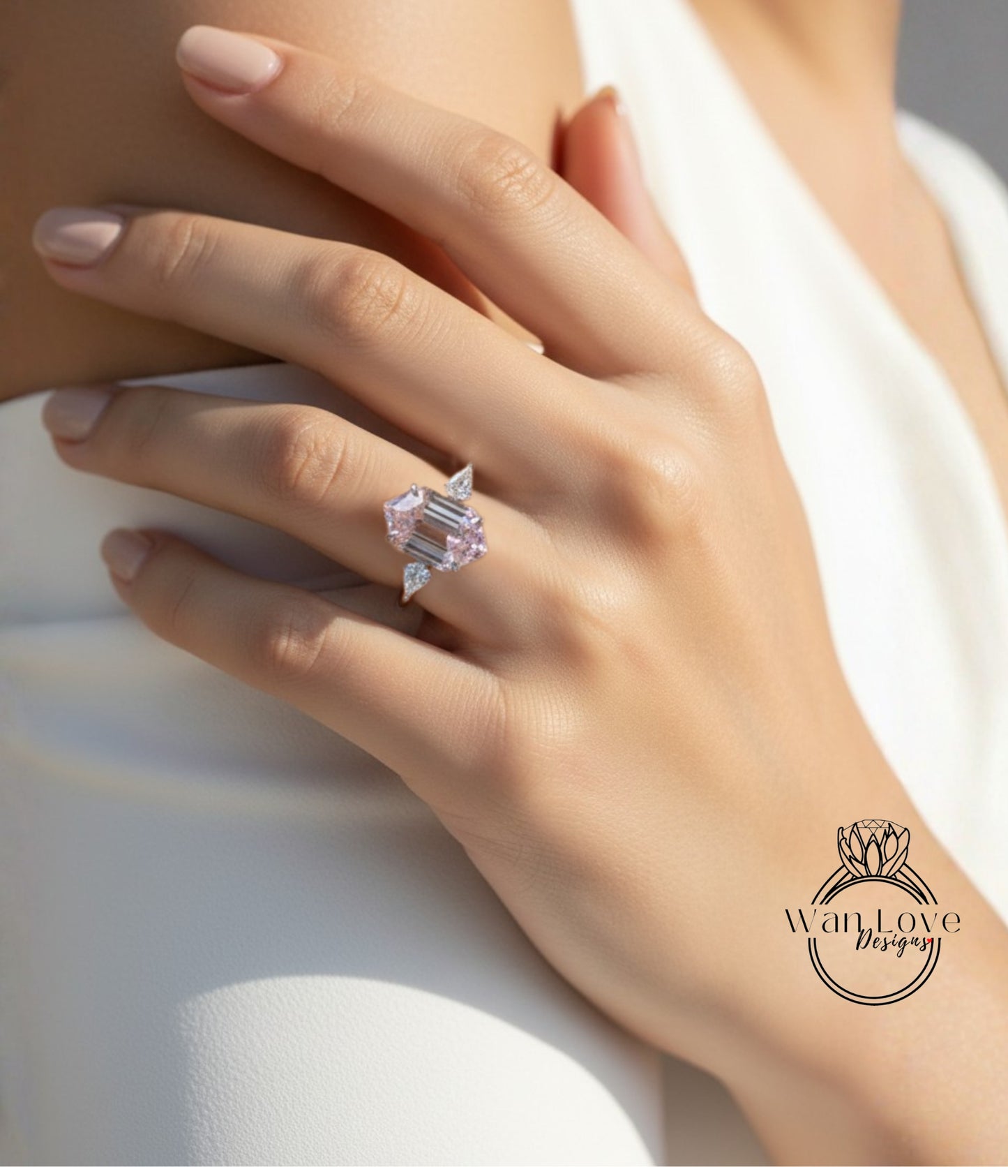 A close-up of a person's hand wearing a large, pink diamond ring.
