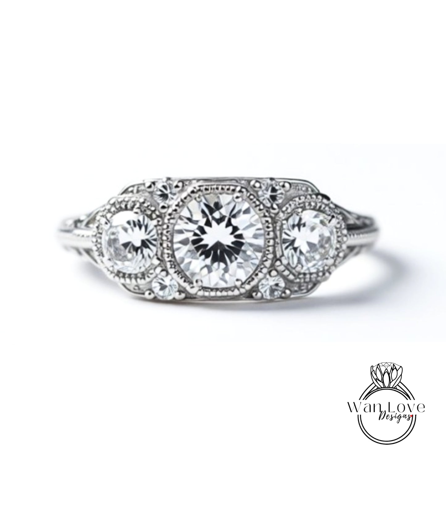 A close-up view of a diamond engagement ring with three large, clear gemstones set in a decorative metal band.