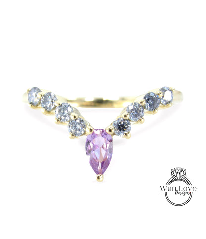 a gold ring with a large purple gemstone in the center, surrounded by smaller diamonds.