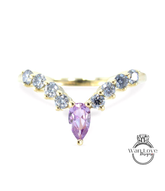 a gold ring with a large purple gemstone in the center, surrounded by smaller diamonds.