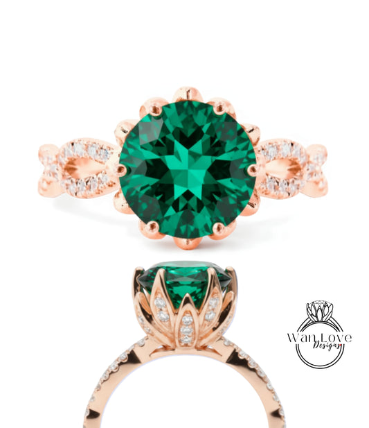 a beautiful engagement ring with a large, round green gemstone surrounded by a delicate floral design and accented with small diamonds.