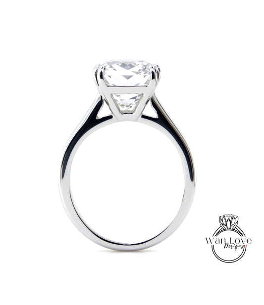 A large, elegant engagement ring with a large, clear gemstone set in a silver band.