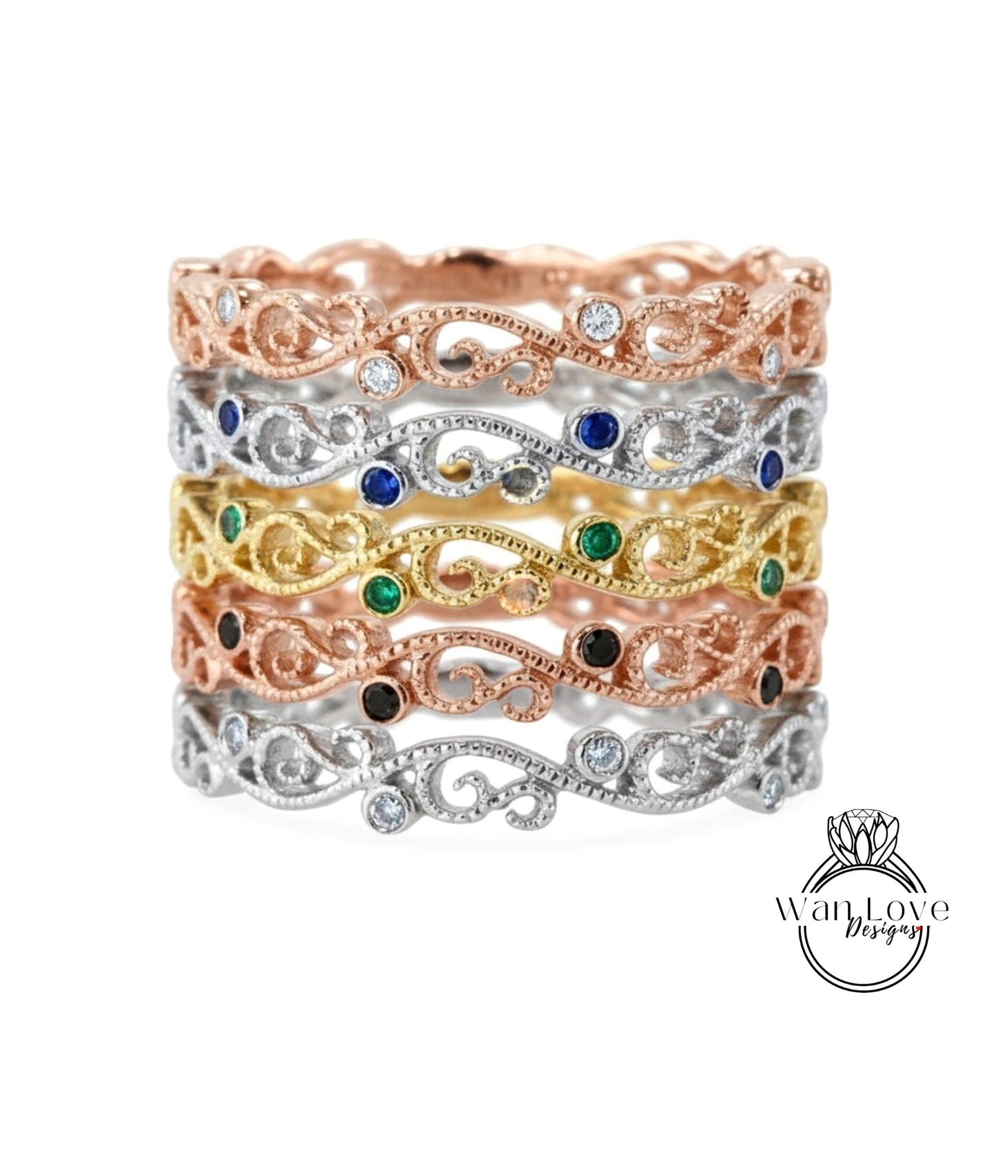 A stack of rings with various colored gemstones and intricate designs.
