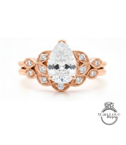 a beautiful engagement ring with a large pear-shaped diamond set in a rose gold band adorned with small diamonds.