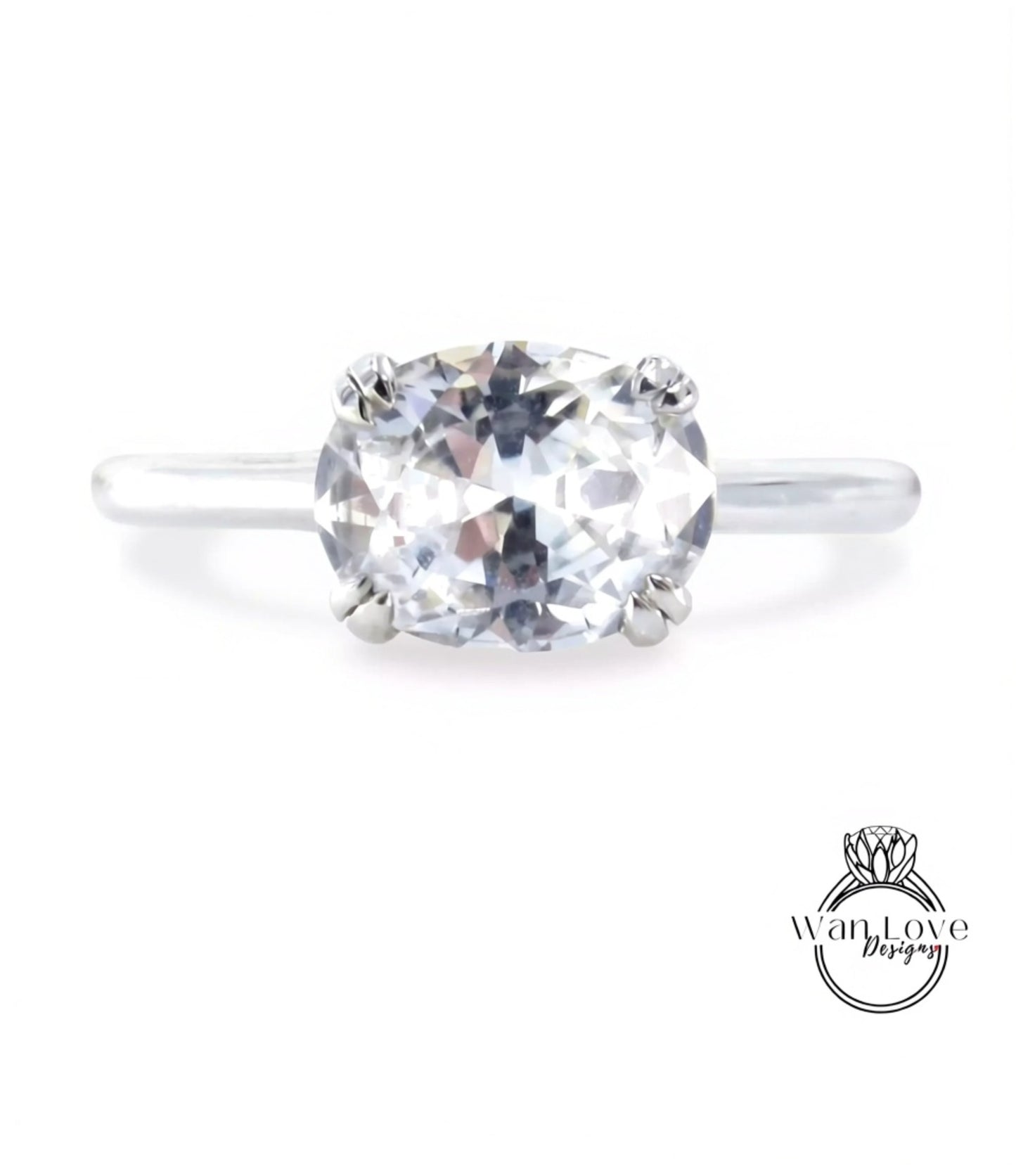 A close-up view of a diamond engagement ring with a large, clear gemstone set in a silver band.