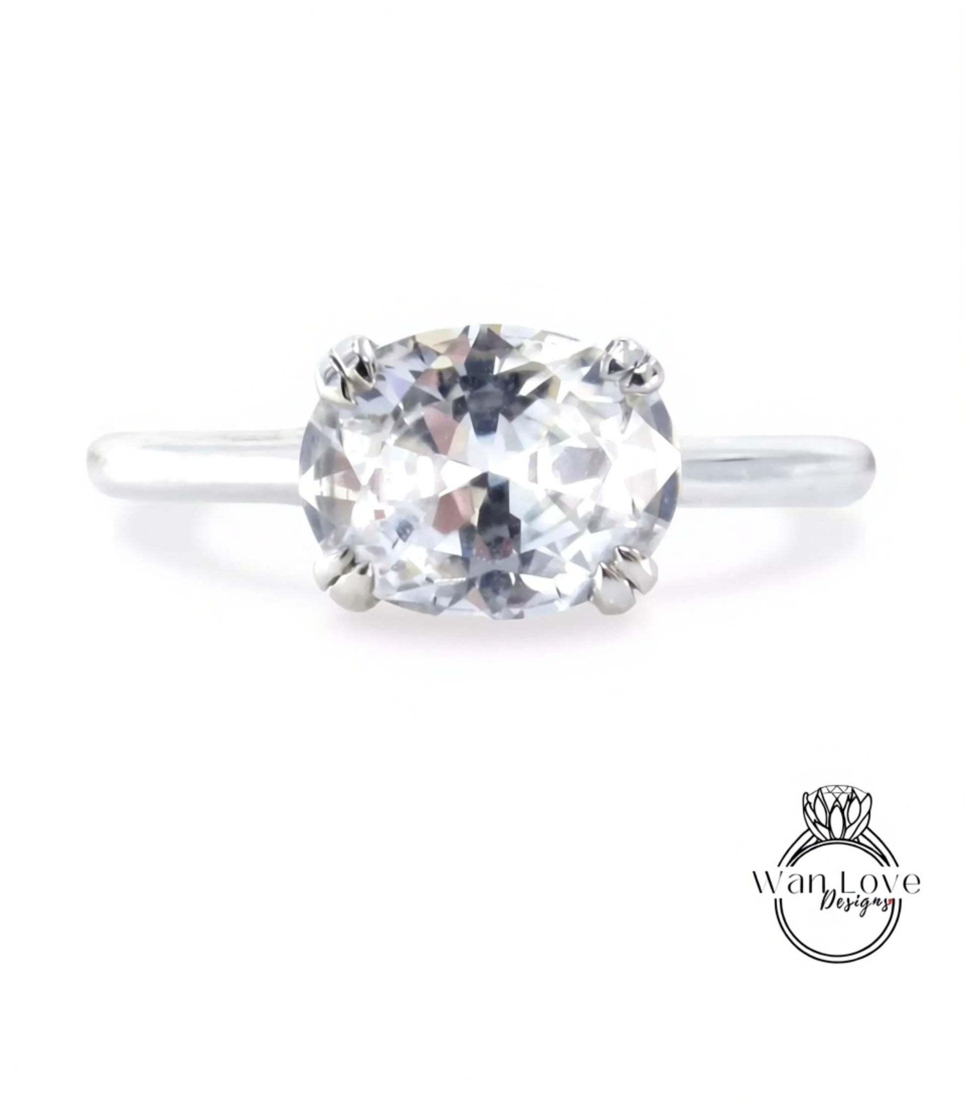 A close-up view of a diamond engagement ring with a large, clear gemstone set in a silver band.