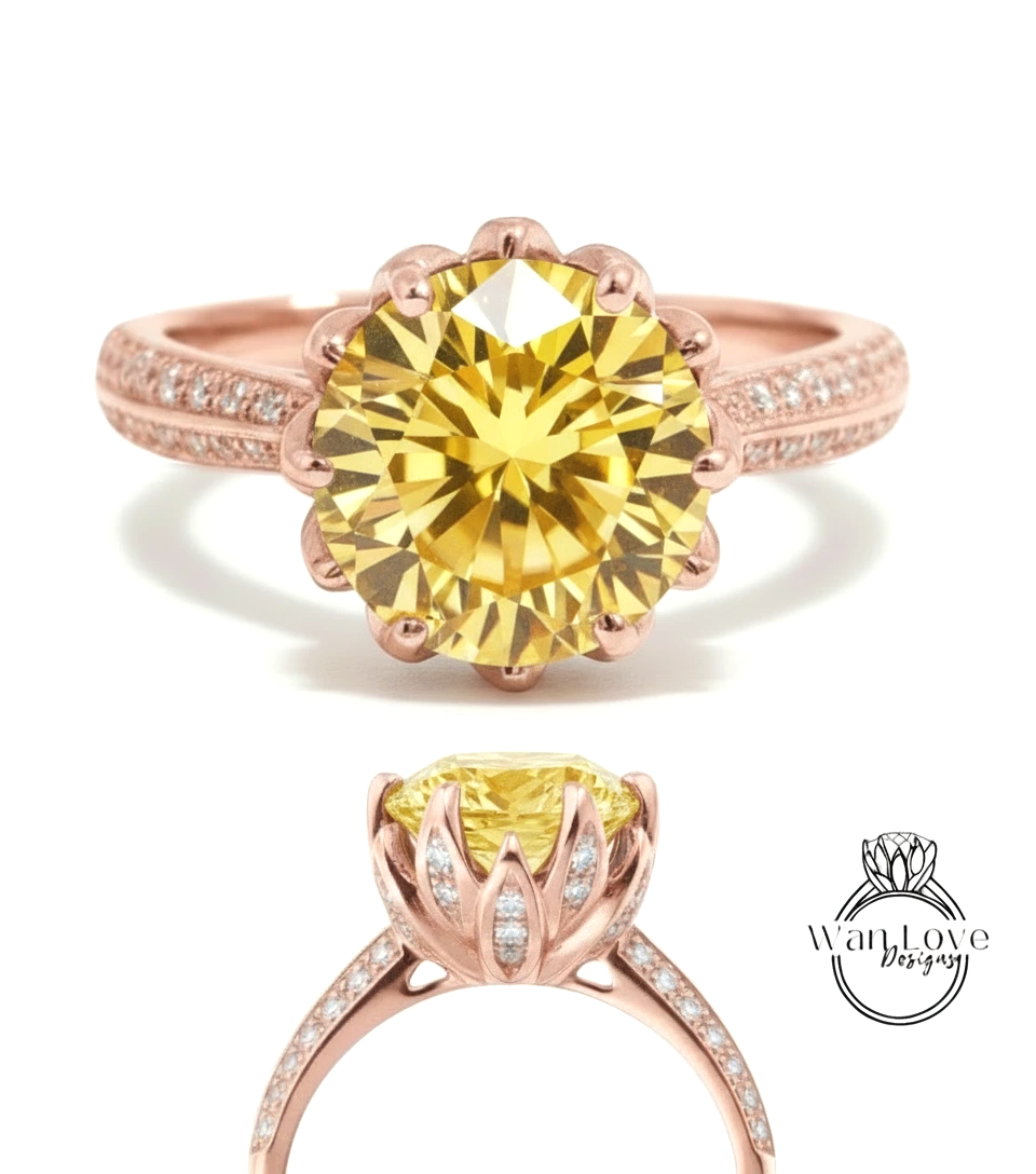 a beautiful yellow diamond engagement ring with a rose gold band and a large central diamond surrounded by smaller diamonds.