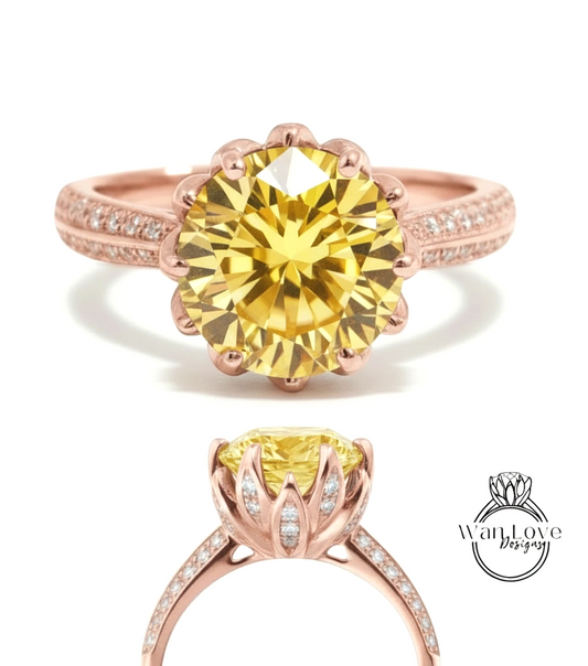a beautiful yellow diamond engagement ring with a rose gold band and a large central diamond surrounded by smaller diamonds.