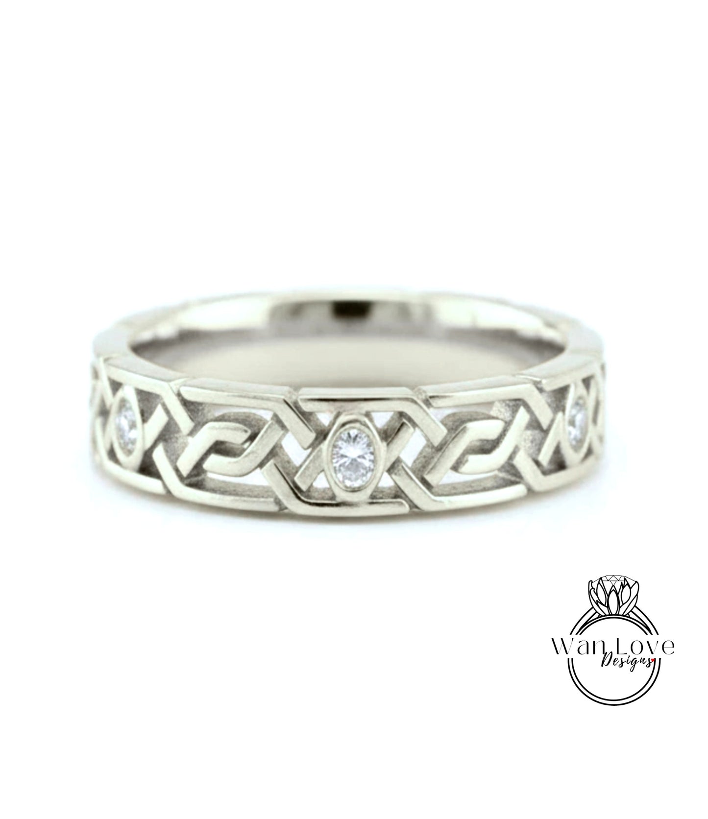 A silver wedding band with a Celtic knot design and a central oval-shaped diamond.