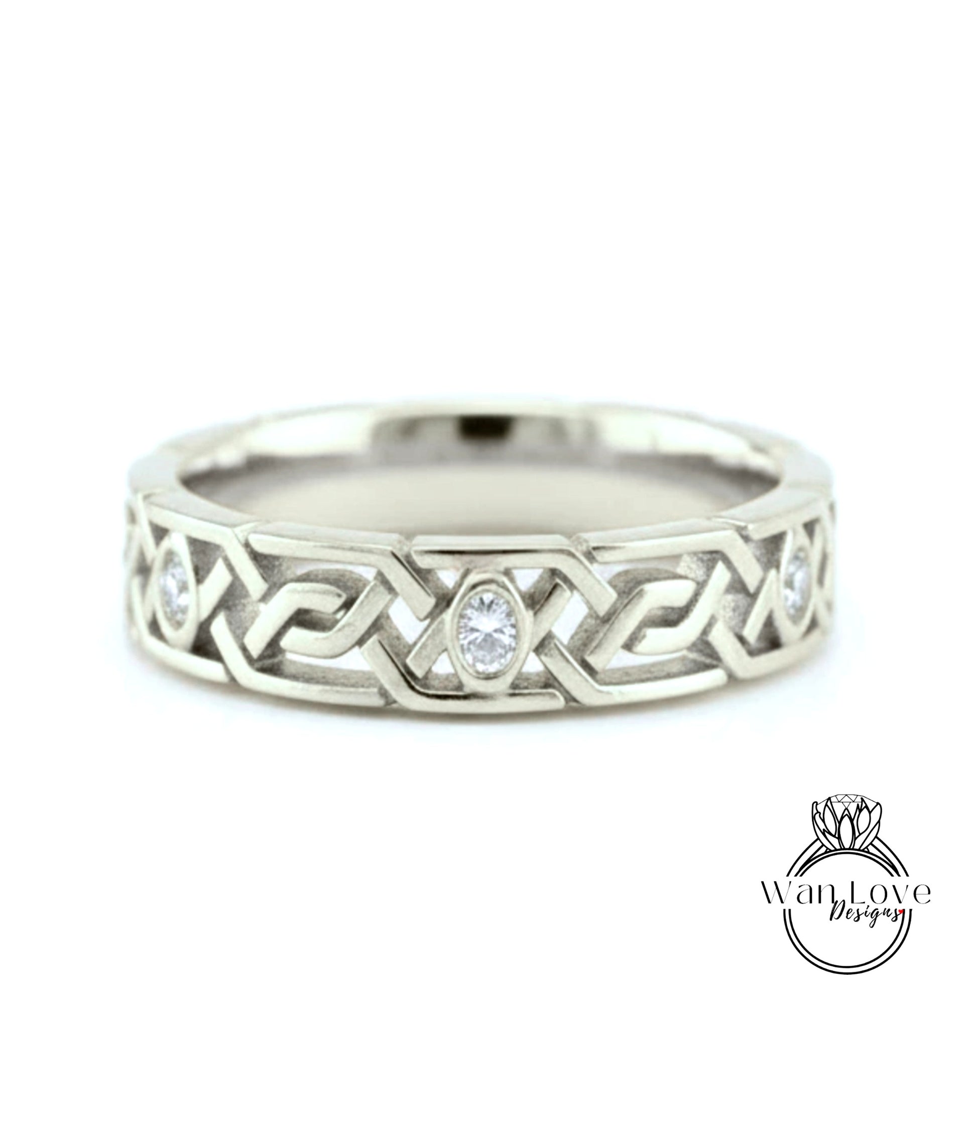 A silver wedding band with a Celtic knot design and a central oval-shaped diamond.