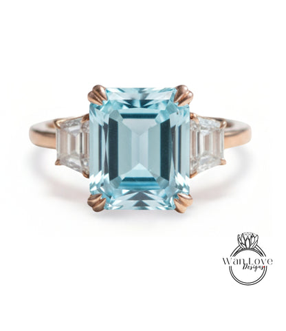 A large, blue gemstone ring with a gold band and three smaller diamonds on either side.