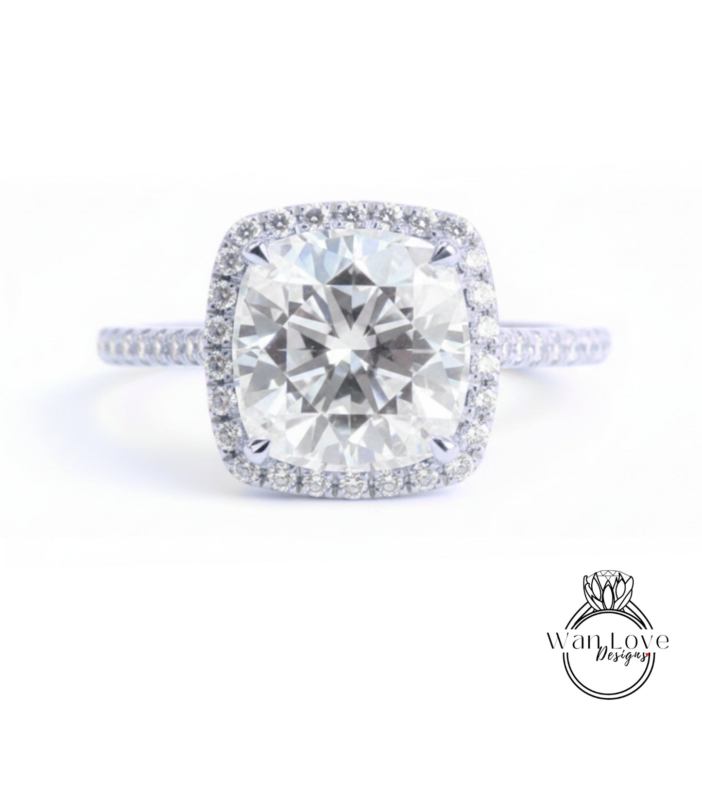 A large, round diamond engagement ring with a halo of smaller diamonds around the center stone.