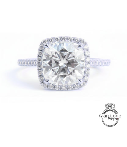 A large, round diamond engagement ring with a halo of smaller diamonds around the center stone.