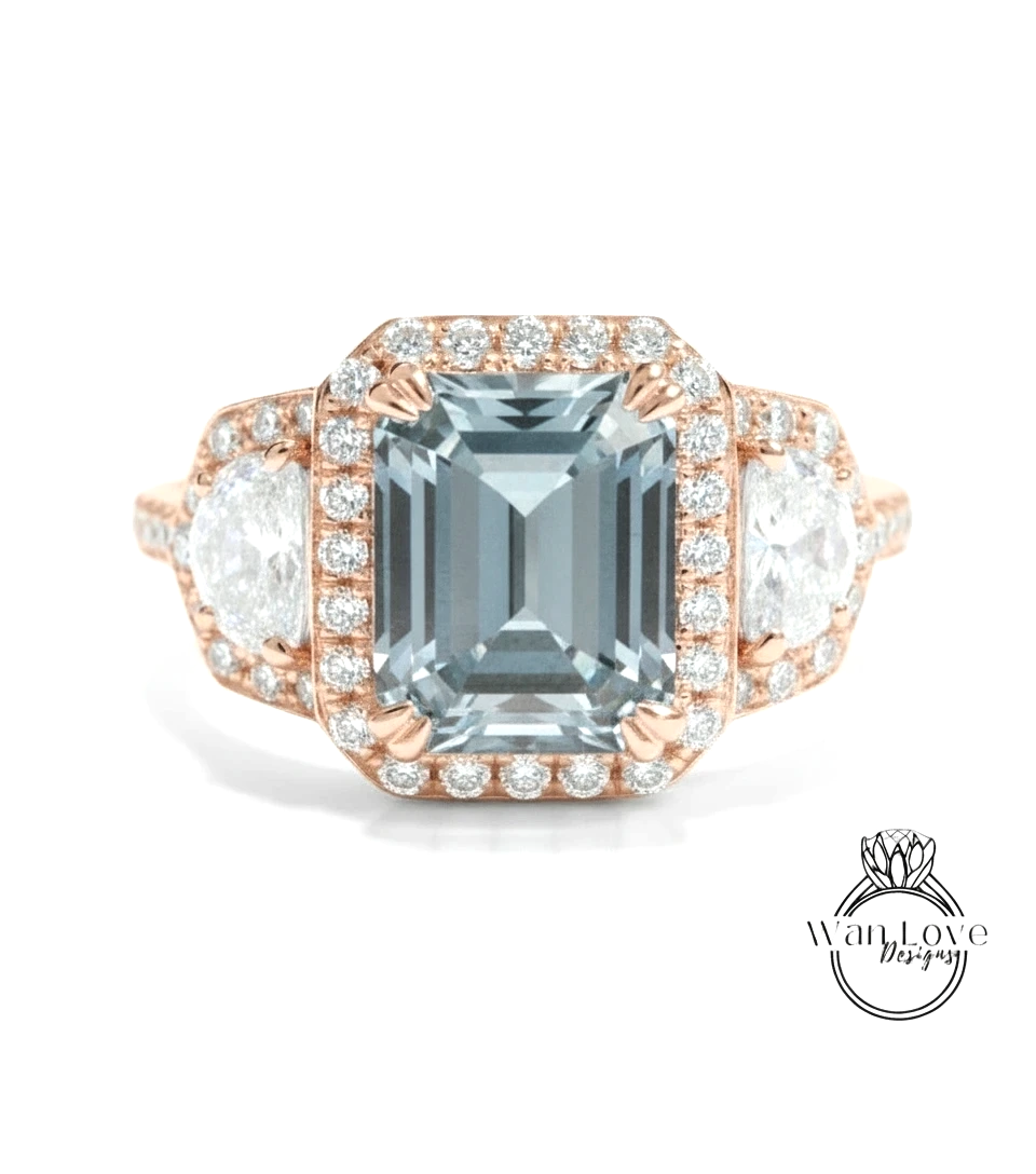 A beautiful engagement ring with a large blue gemstone surrounded by smaller diamonds and a halo of smaller diamonds.