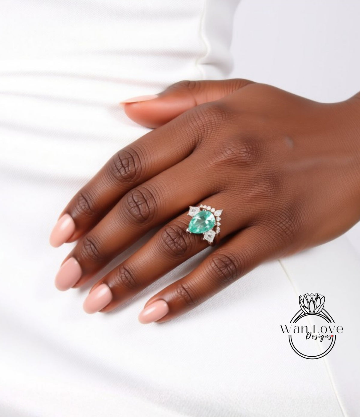 A close-up of a hand wearing a ring with a large, green gemstone.