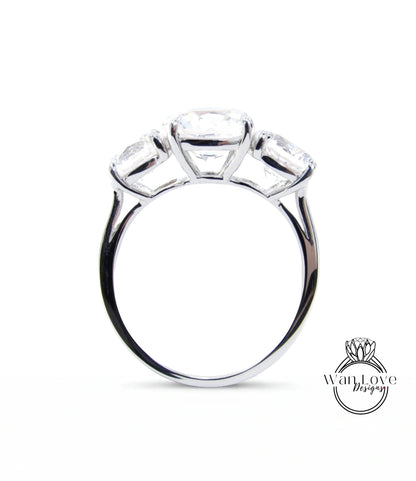 A silver ring with three large diamonds set in the center.