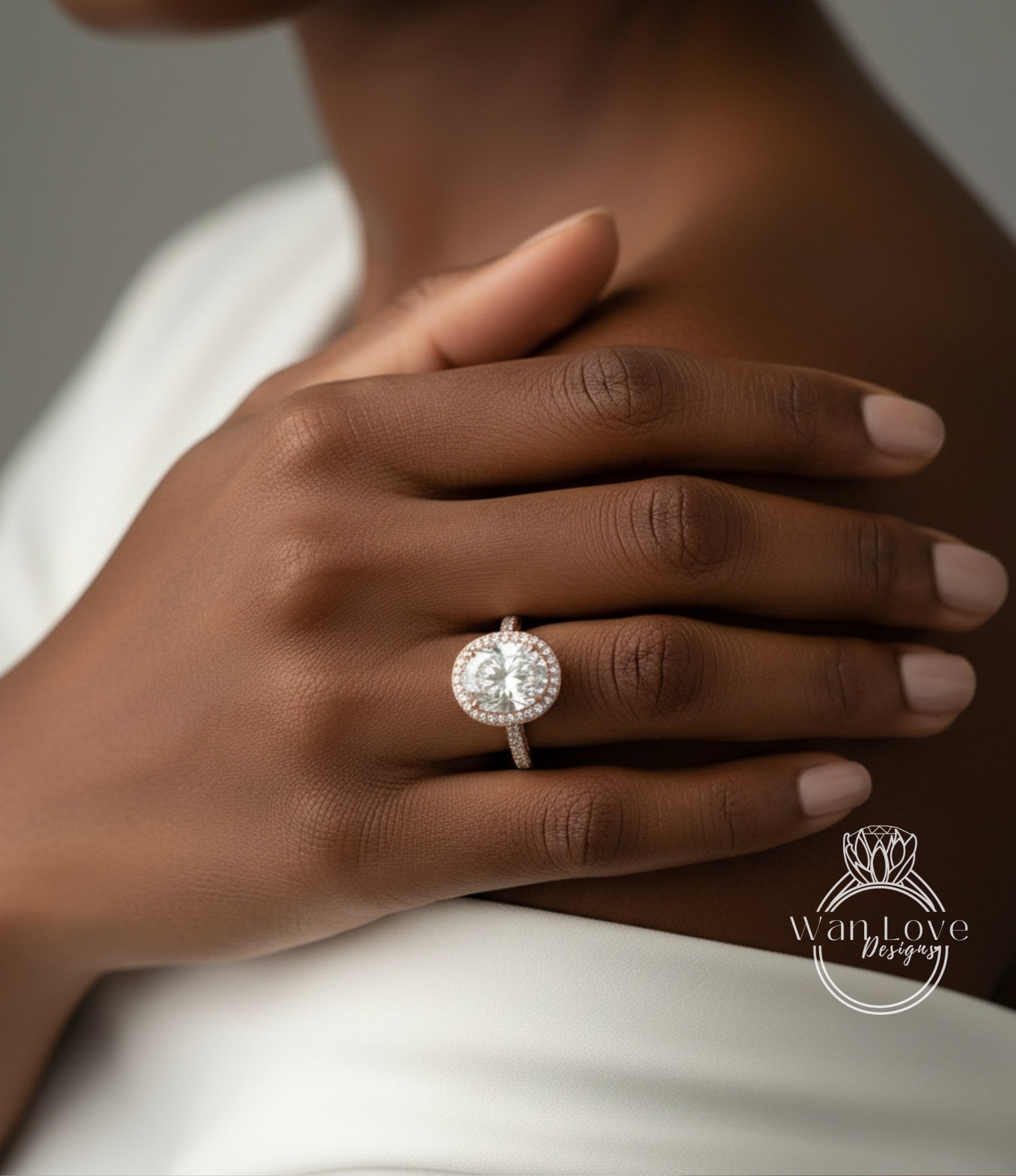 A close-up of a person's hand wearing a large, round diamond engagement ring.