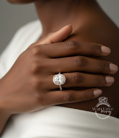A close-up of a person's hand wearing a large, round diamond engagement ring.