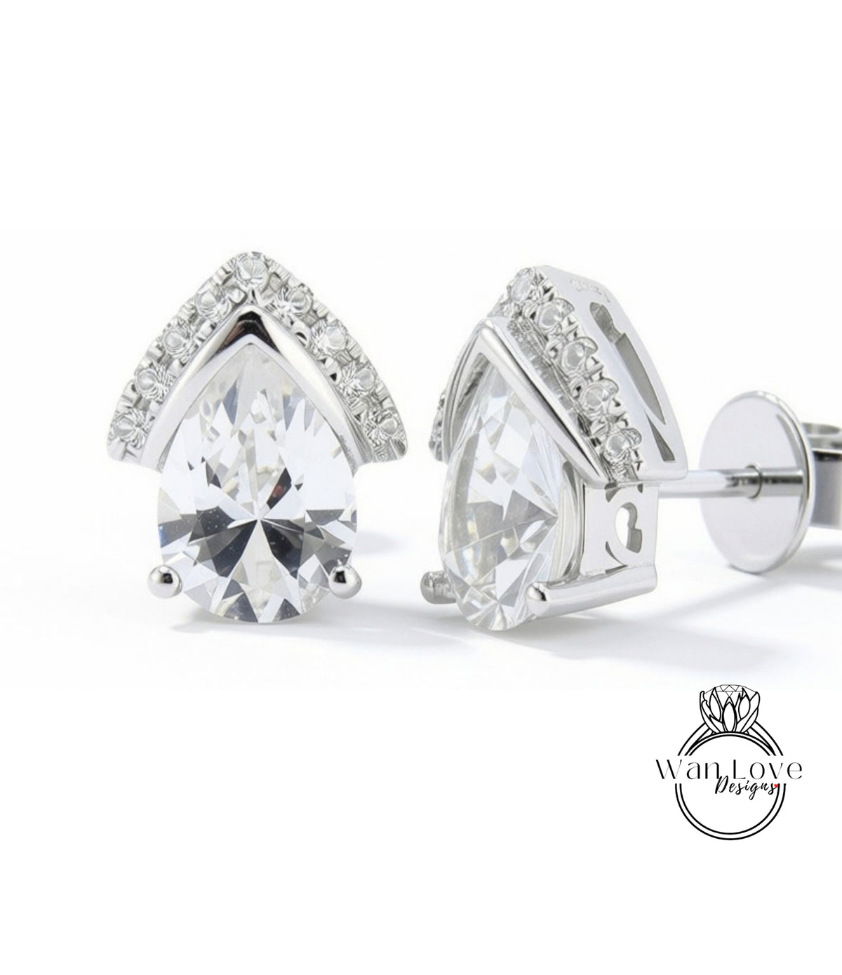 A pair of elegant silver earrings with large, clear gemstones set in a pointed design.
