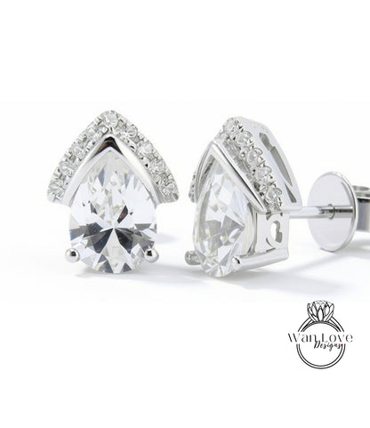 A pair of elegant silver earrings with large, clear gemstones set in a pointed design.
