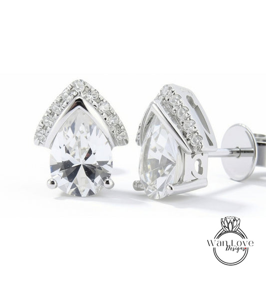 A pair of elegant silver earrings with large, clear gemstones set in a pointed design.