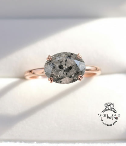 A rose gold ring with a large oval-shaped diamond as the centerpiece.
