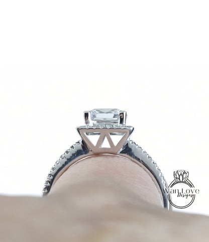 A close-up view of a diamond engagement ring on a person's finger, showcasing the intricate design and sparkling gemstone.