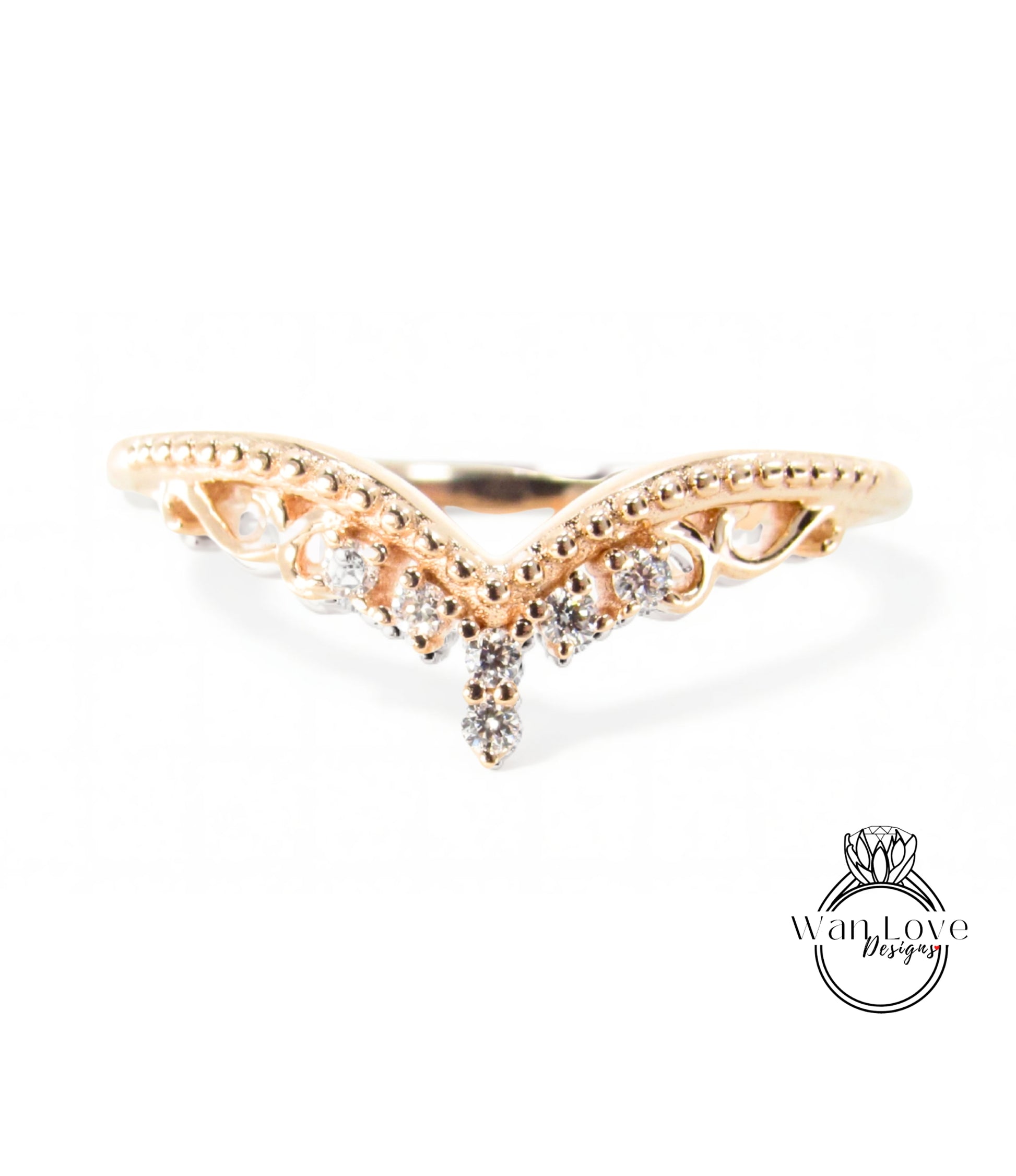 A gold ring with a decorative design featuring a central diamond and smaller diamonds surrounding it.