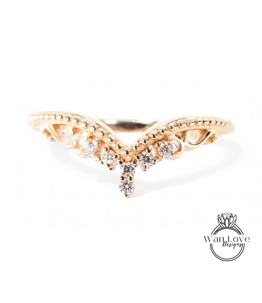 A gold ring with a decorative design featuring a central diamond and smaller diamonds surrounding it.