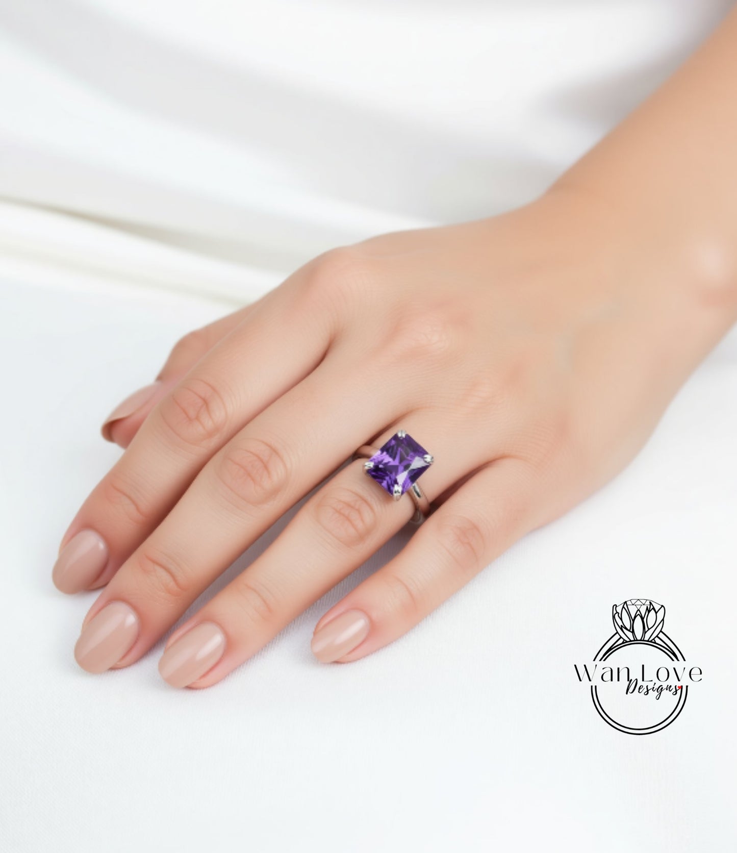 A close-up of a hand wearing a ring with a large purple gemstone.