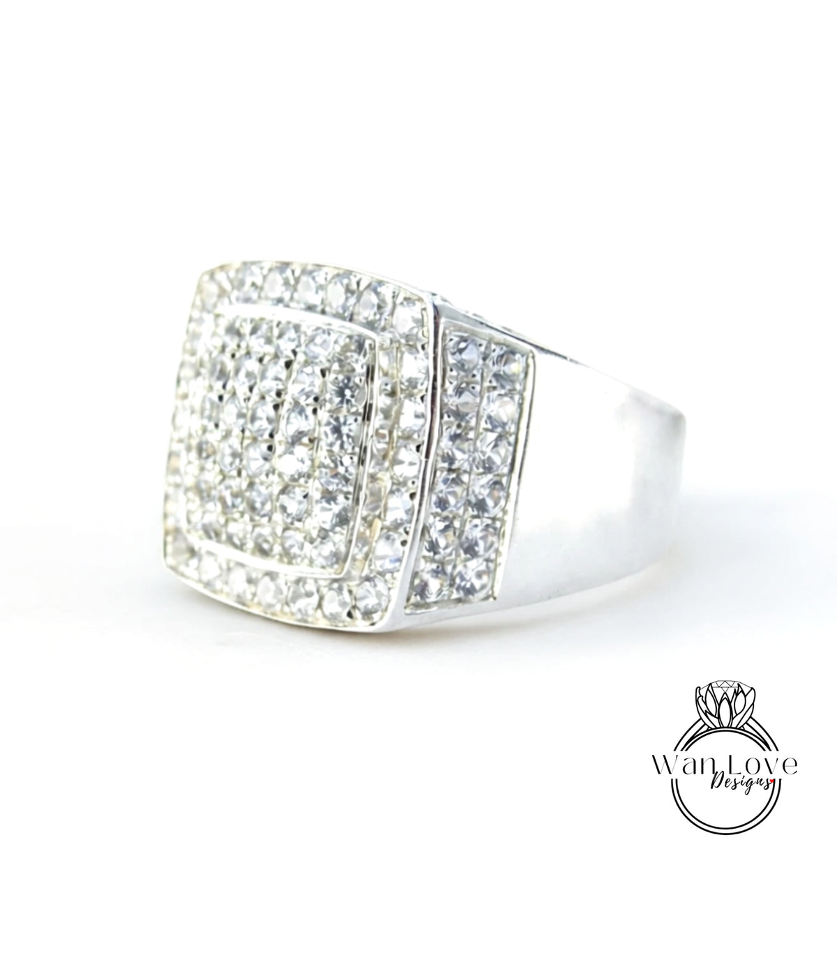 A silver ring with a large diamond-encrusted square cut gemstone.