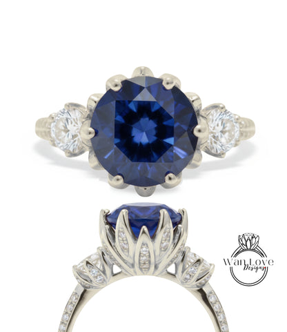 a stunning blue gemstone ring with a large central blue gemstone surrounded by smaller diamonds. The ring is set in a silver band with a delicate floral design.