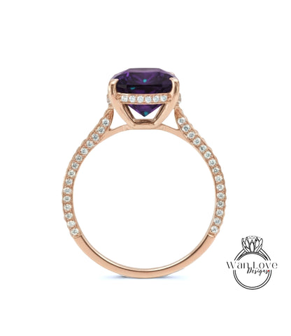 A gold ring with a large purple gemstone set in the center, surrounded by smaller diamonds.