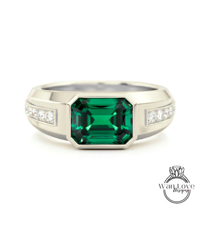 A silver ring with a large, green gemstone in the center.