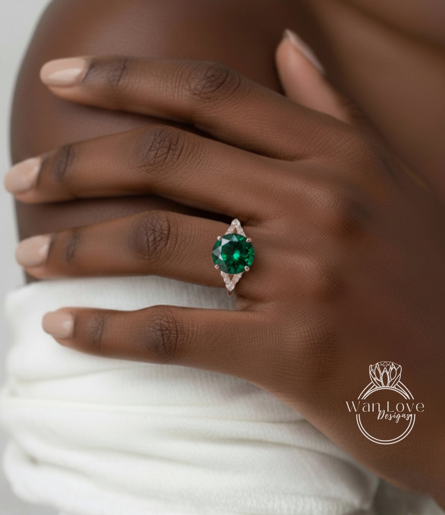 A close-up of a person's hand wearing a ring with a large, green gemstone.