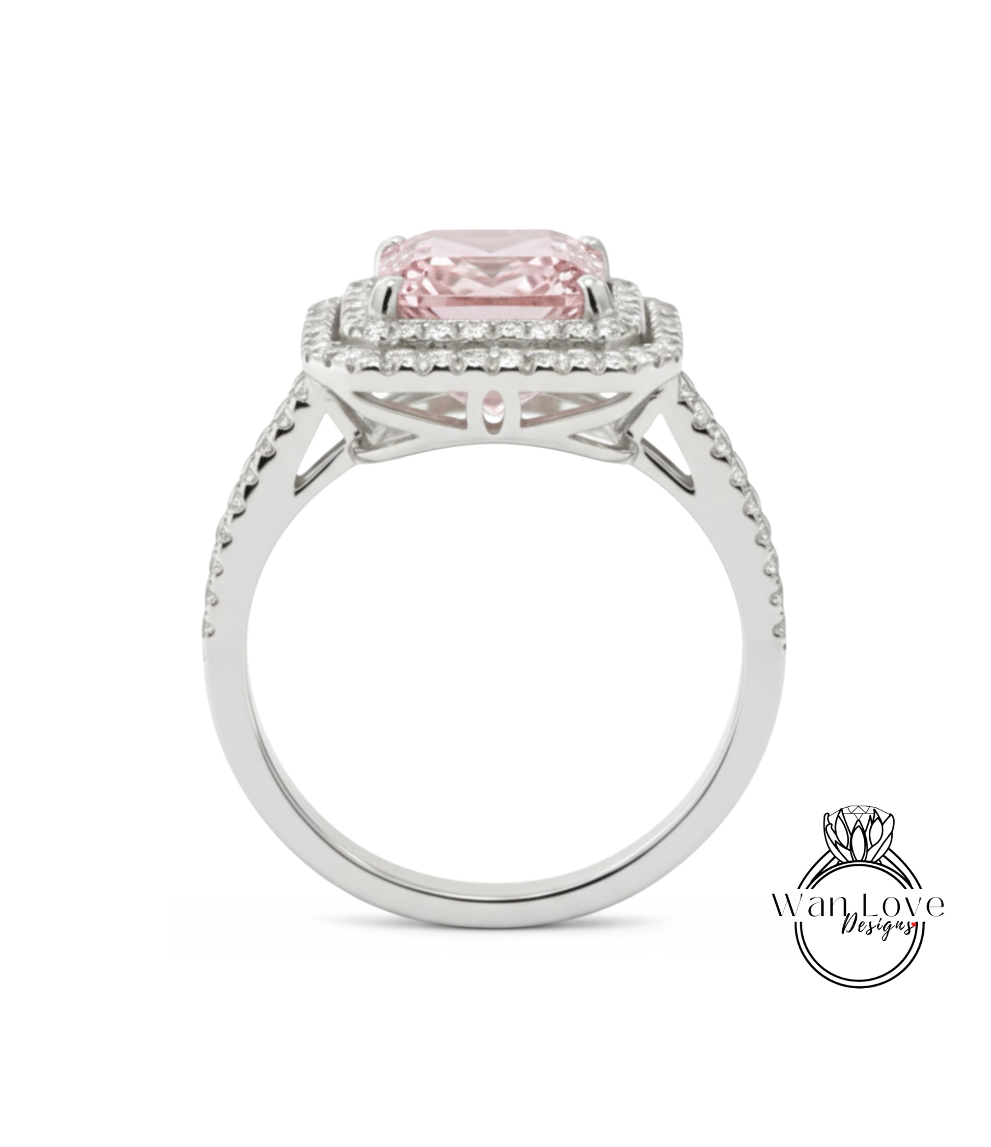 A silver ring with a large pink gemstone, likely a diamond, set in the center.