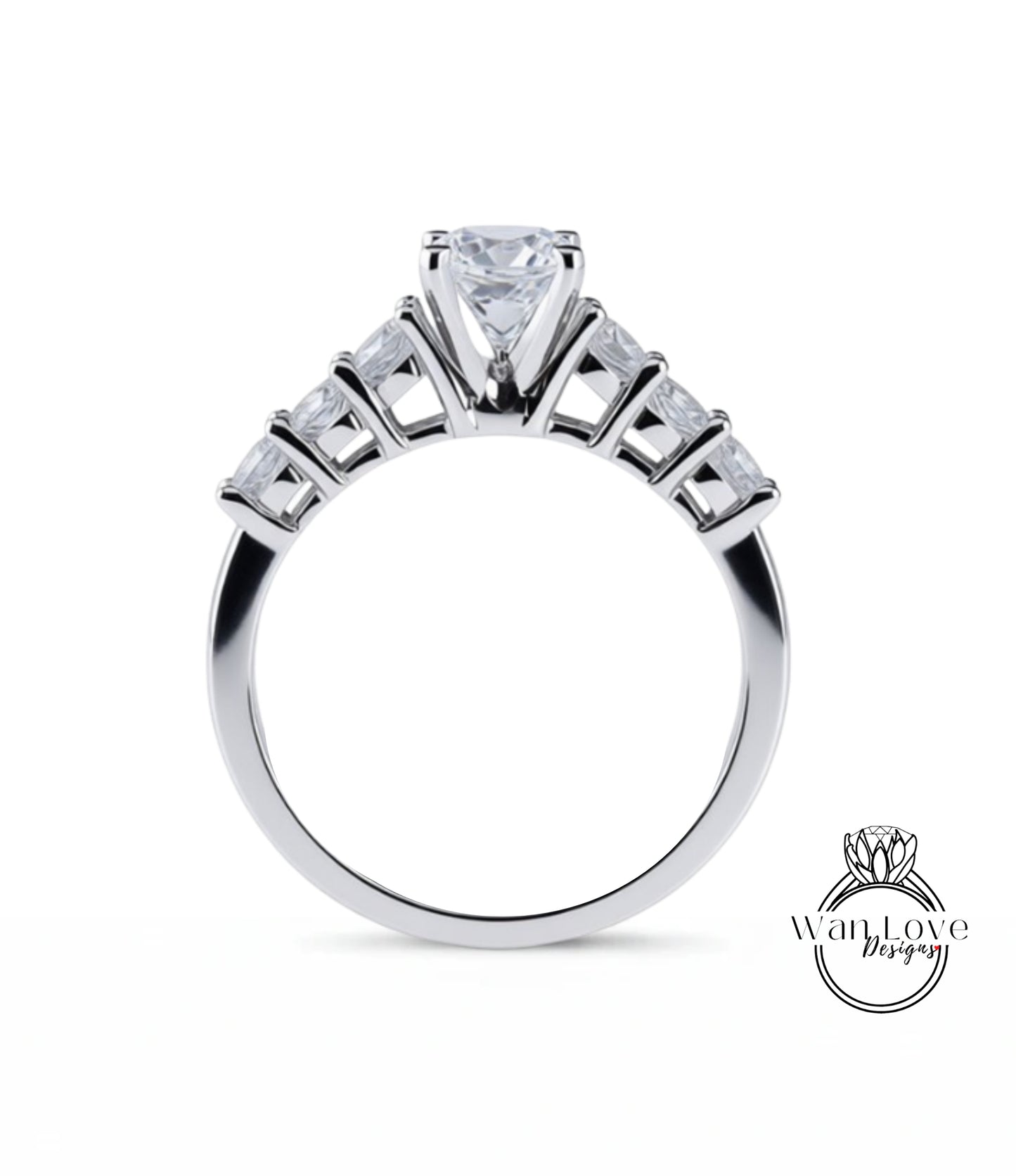 A close-up view of a silver engagement ring with a large central diamond surrounded by smaller diamonds arranged in a fan-like design on the band.