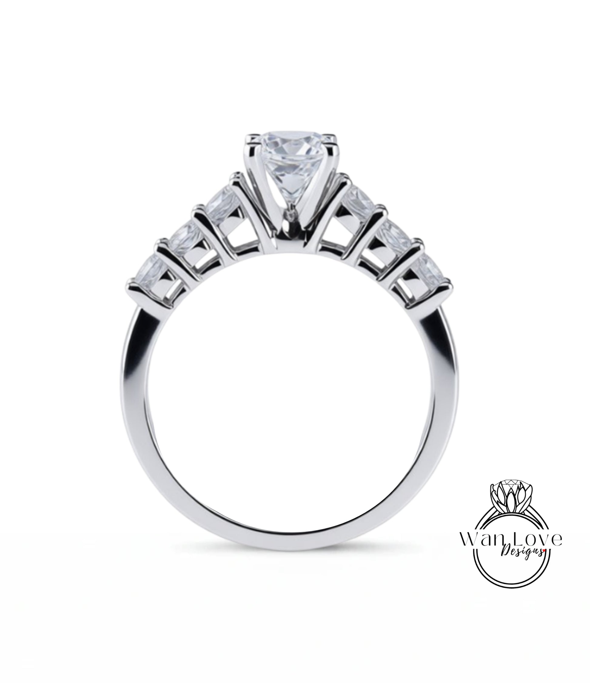 A close-up view of a silver engagement ring with a large central diamond surrounded by smaller diamonds arranged in a fan-like design on the band.