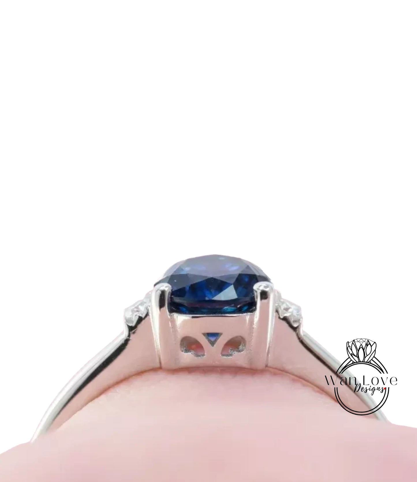 A close-up view of a silver ring with a large blue gemstone, showcasing the intricate design and craftsmanship of the piece.