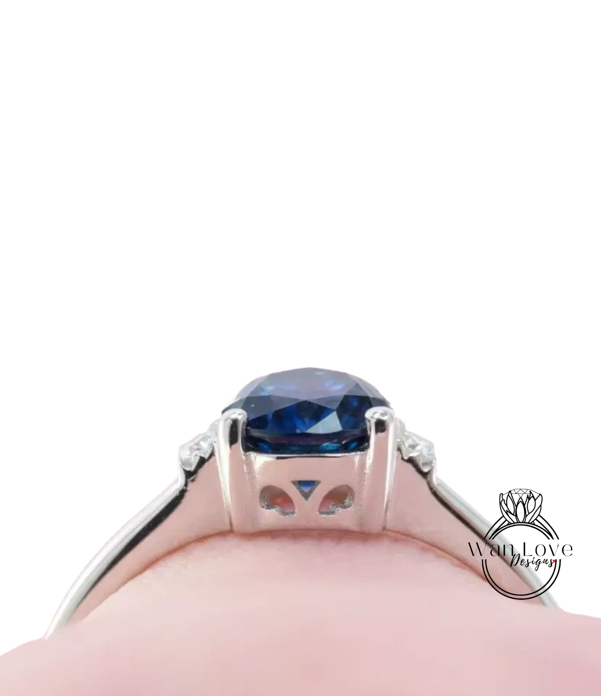 A close-up view of a silver ring with a large blue gemstone, showcasing the intricate design and craftsmanship of the piece.