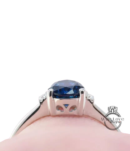 A close-up view of a silver ring with a large blue gemstone, showcasing the intricate design and craftsmanship of the piece.