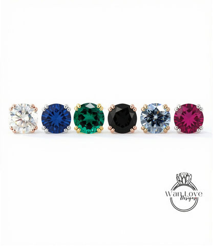 A row of six colorful gemstone earrings, each with a unique color and design, arranged in a straight line.