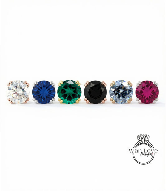 A row of six colorful gemstone earrings, each with a unique color and design, arranged in a straight line.