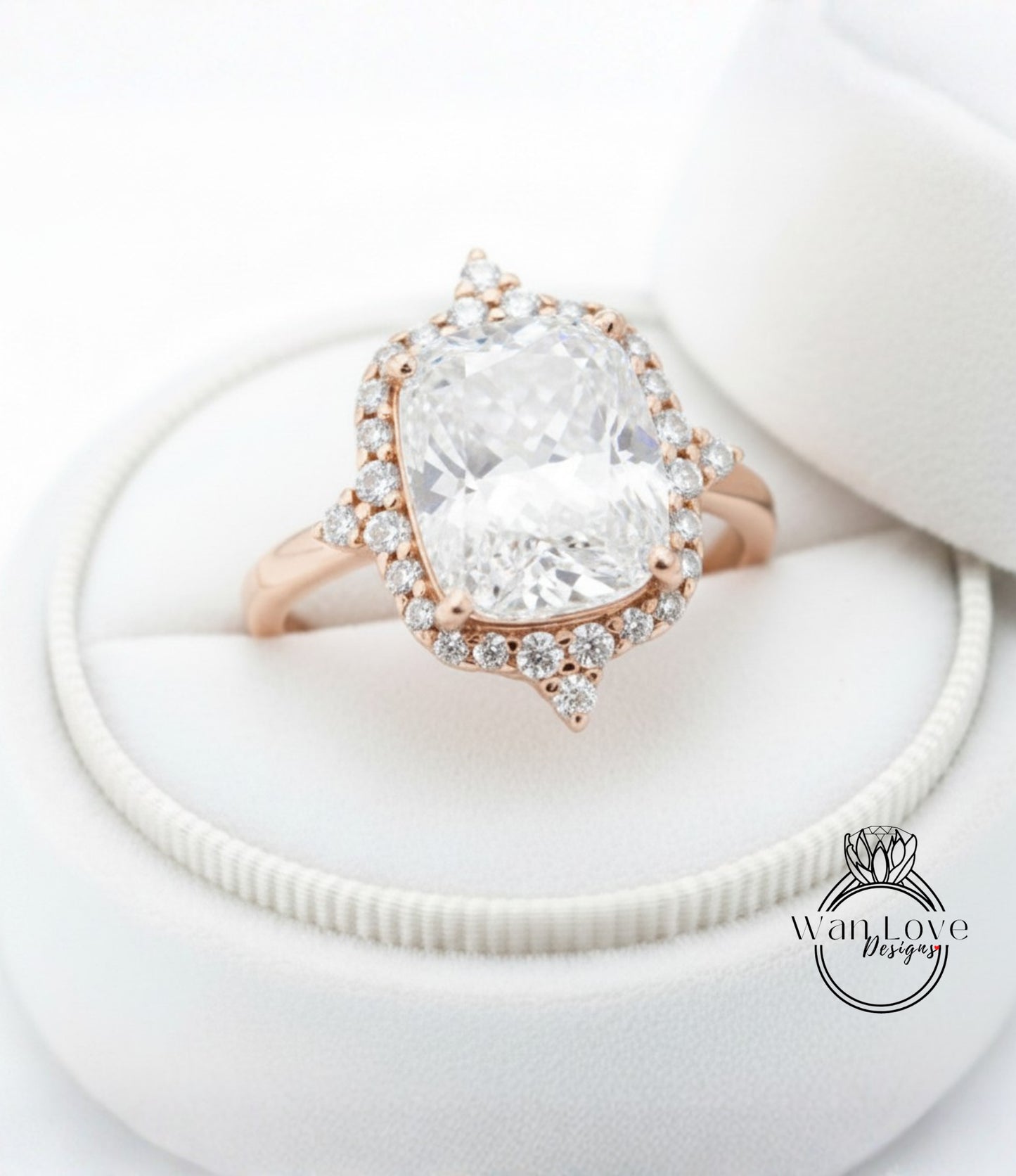 A large, clear diamond engagement ring with a halo of smaller diamonds around the center stone, displayed in a white jewelry box.