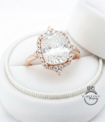 A large, clear diamond engagement ring with a halo of smaller diamonds around the center stone, displayed in a white jewelry box.