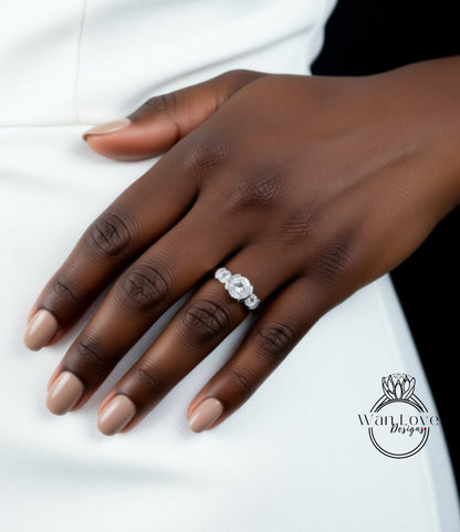 A close-up of a person's hand wearing a diamond engagement ring.