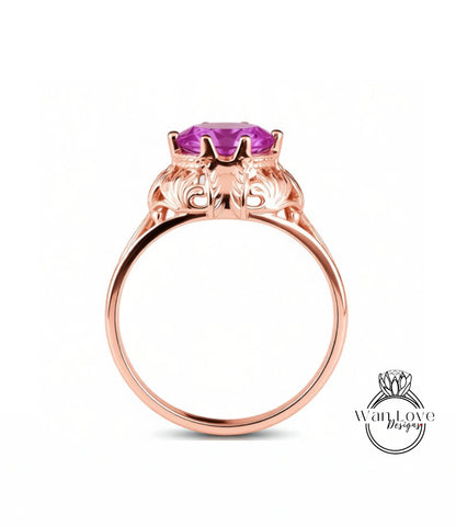 A rose gold ring with a large purple gemstone set in the center.