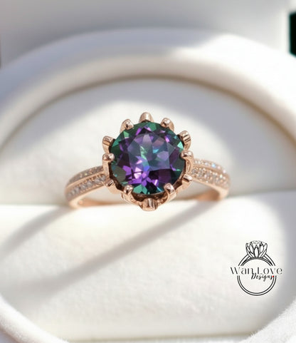 A close-up image of a gold ring with a large, colorful gemstone, likely a diamond, set in the center of the band.