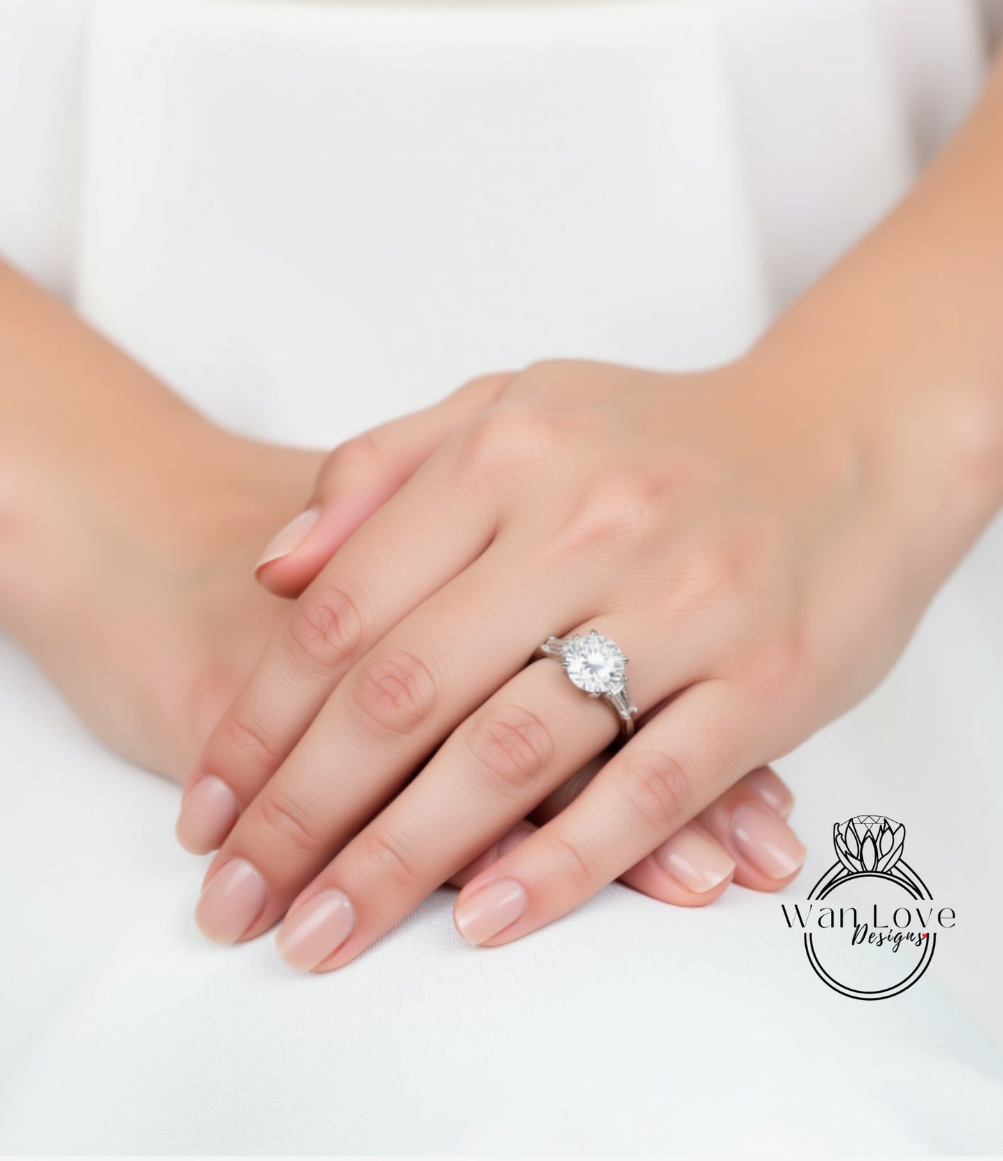 A close-up image of a person's hands wearing a diamond engagement ring.